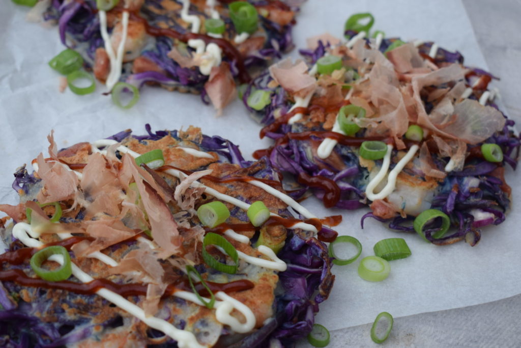 Japanse okonomiyaki met paarse spitskool en bonito